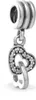 A close-up studio shot of a silver Pandora charm with two intertwined hearts, one encrusted with small clear stones. Podgląd zdjęcia produktu