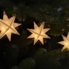 Close-up of white star-shaped LED lights on a Christmas tree. Produktbild-Vorschau