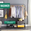 A clothing rack with clothes, bags, and storage bins, set up in a room. Voir les images du produit