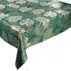 A close-up view of a tablecloth with a monstera leaf pattern. Produktbild-Vorschau
