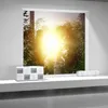 A box of paper towels is placed on a white shelf in front of a window showing a bright sunlit garden. Náhled obrázku produktu