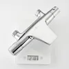 A chrome shower thermostat is placed on a digital scale against a white background. Produktbild-Vorschau