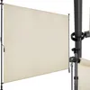 A close-up view of a beige retractable awning mounted on a dark pole. Náhled obrázku produktu