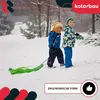 Two children are playing in the snow with a green sled. Náhled obrázku produktu
