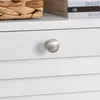 A close-up of a white drawer with a silver knob, and a basket and books on top. Anteprima dell’immagine prodotto