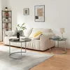 A living room scene with a couch, coffee tables, and a bookshelf. Voir les images du produit