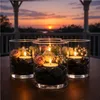 Schwarze Deko-Kiesel in Glasschalen mit Kerzen und Blumen zur Tischdekoration Produktbild-Vorschau