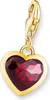 A close-up studio shot of a gold heart-shaped charm with a red gemstone. Náhled obrázku produktu