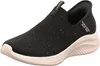 A black Skechers slip-on sneaker with pink accents and glitter details, shown from a side-front angle on a white background. Náhľad obrázku produktu