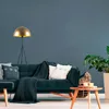 A living room scene with a sofa, floor lamp, and side table. Produktbild-Vorschau
