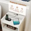 A white nightstand with a charging station, phone, smartwatch, and tablet. Produktbild-Vorschau