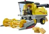 A toy combine harvester with a figure driving it, and some toy bales of hay in front of it. Anteprima dell’immagine prodotto