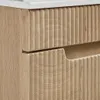 A close-up view of a wooden vanity with fluted drawer fronts. Anteprima dell’immagine prodotto