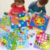 Two children are playing with a button mosaic toy on a table. Produktbild-Vorschau