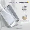 A stainless steel cat litter box is shown with water being poured into it, demonstrating its ease of cleaning. Inset images highlight features like preventing urine leakage and non-stick litter. Produktbild-Vorschau