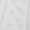 A close-up view of a white quilted comforter with tufted buttons. Produktbild-Vorschau