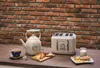A breakfast setting with a kettle, toaster, and toast. Anteprima dell’immagine prodotto