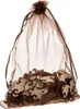 A brown organza bag filled with wooden puzzle pieces. Náhľad obrázku produktu