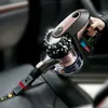 A hand holds a cordless vacuum cleaner, cleaning a car seat. Produktbild-Vorschau