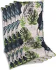 A stack of chair cushions with a tropical leaf pattern. Produktbild-Vorschau