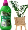 A bottle of plant fertilizer and a potted plant on a stool. Produktbild-Vorschau