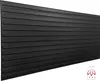 A black textured panel with horizontal lines, presented at an angle against a white background. A small logo is visible in the bottom right corner. Náhled obrázku produktu