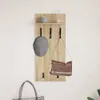 A wall-mounted coat rack with a shelf, hooks, a hat, and a bag hanging on it. Náhled obrázku produktu
