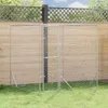An outdoor dog kennel made of galvanized steel is set up on a grassy lawn in front of a wooden fence and a lattice fence. Náhľad obrázku produktu