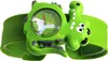 A close-up studio shot of a child's green crocodile-shaped watch. Voir les images du produit