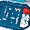 A close-up view of a Battleship board game, showing the game board with ships and pegs, and storage compartments for red and white pegs. Produktbild-Vorschau
