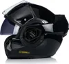 A black motorcycle helmet with the chin bar lifted, showing the internal sun visor. Produktbild-Vorschau