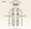 A marketing image showcasing two silver door handles against a light patterned background, framed by an arch. Produktbild-Vorschau