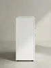 Moderner Beistellschrank mit matten weißen Oberflächen und silbernen Griffdetails leicht schräg aus der Frontperspektive abgelichtet._#sku_BARWL5.287# Produktbild-Vorschau