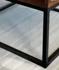 Close-up of the corner of a coffee table showing its metal frame and wooden top. Produktbild-Vorschau