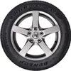 A close-up studio shot of a car tire mounted on a silver rim, presented against a white background. Podgląd zdjęcia produktu