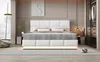 A modern bedroom with a white upholstered bed as the focal point. Produktbild-Vorschau