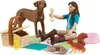 A toy picnic set with a girl, a dog, a squirrel, a picnic basket, food, and a bowl. Produktbild-Vorschau