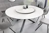 A round dining table with chairs in a modern dining room setting. Produktbild-Vorschau