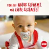 A baby is crawling on the floor wearing a pacifier. Produktbild-Vorschau