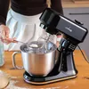A person is adding flour to a stand mixer. Náhľad obrázku produktu
