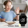 A young girl wearing headphones is sitting at a desk, looking at a laptop and waving. A smartwatch is on her wrist, displaying a 'school mode' icon. Produktbild-Vorschau