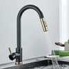 A black and gold kitchen faucet with water running into a sink. Náhľad obrázku produktu