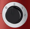 A close-up view of a red kitchen appliance with a black control dial. Produktbild-Vorschau