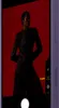 A person is posing in front of a red background, with a phone interface overlaid on the image. Podgląd zdjęcia produktu