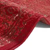 A close-up view of a red rug with a distressed pattern, showing the texture and edge. Produktbild-Vorschau