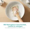 A hand is cleaning a white sink with a soapy cloth. Produktbild-Vorschau