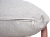 A close-up view of a beige cushion with a zipper. Podgląd zdjęcia produktu