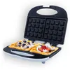 An open waffle maker with two waffles topped with cream and fruit. Anteprima dell’immagine prodotto