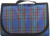 A folded picnic blanket with a blue plaid pattern and black trim. Produktbild-Vorschau