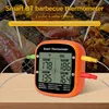 A smart barbecue thermometer displaying temperatures for four probes, with meat cooking on a grill in the background. Náhled obrázku produktu